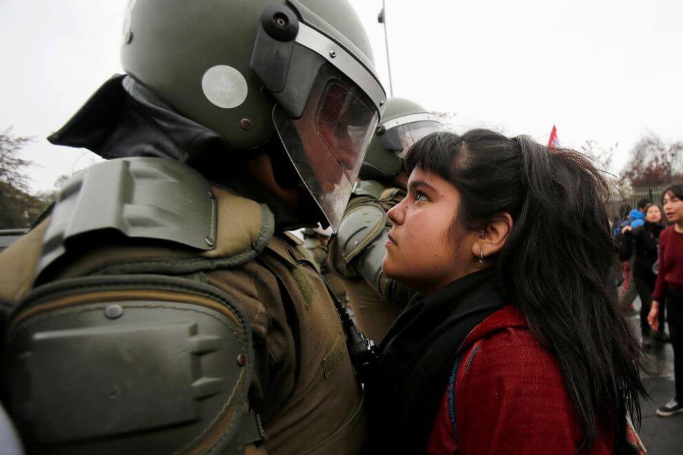 In Santiago an Intense moment between a woman and policeman by Carlos Vera